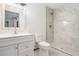Bathroom with a white vanity, toilet, and a tiled shower with glass doors at 1477 Olive Sw St, Atlanta, GA 30310
