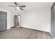 Bedroom with gray doors, gray trim, wood-look floors, and a ceiling fan at 1477 Olive Sw St, Atlanta, GA 30310