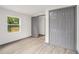 Bedroom featuring gray vinyl floors, gray bi-fold closet doors and natural light at 1477 Olive Sw St, Atlanta, GA 30310