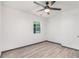 A bright bedroom is displayed with wood-look flooring, a ceiling fan, and one window at 1477 Olive Sw St, Atlanta, GA 30310