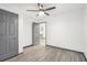 Bedroom featuring gray doors, a ceiling fan, and wood-look flooring at 1477 Olive Sw St, Atlanta, GA 30310