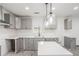 View of the kitchen showcasing gray cabinets, white countertops, and stainless steel appliances at 1477 Olive Sw St, Atlanta, GA 30310