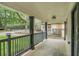 Covered porch boasts gray railing, black pillars, and access to the front door at 1477 Olive Sw St, Atlanta, GA 30310