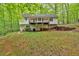 Backyard view of a two-story home featuring a deck and a lawn at 2539 Lakeside Dr, Villa Rica, GA 30180