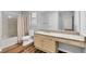 Bathroom with granite countertop, shower-tub combo and wood floor at 2539 Lakeside Dr, Villa Rica, GA 30180