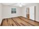Bedroom featuring wood floor, ceiling fan, a window and an open door at 2539 Lakeside Dr, Villa Rica, GA 30180
