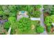 Aerial view of a home with a large, in-ground pool, lush landscaping, and mature trees at 5475 Trowbridge Dr, Dunwoody, GA 30338