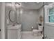 Well-lit bathroom offers a stylish vanity, toilet, and glass enclosed shower at 5475 Trowbridge Dr, Dunwoody, GA 30338