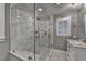 Elegant bathroom features a glass enclosed shower with marble tile and a modern vanity at 5475 Trowbridge Dr, Dunwoody, GA 30338