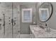 Beautiful bathroom with luxurious walk-in shower and custom marble vanity and fixtures at 5475 Trowbridge Dr, Dunwoody, GA 30338