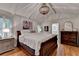 Comfortable bedroom features hardwood floors, plantation shutters, and ensuite bath access at 5475 Trowbridge Dr, Dunwoody, GA 30338