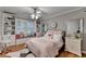 Charming bedroom with built-in shelving, window seat, and a comfortable bed with a lovely pink comforter at 5475 Trowbridge Dr, Dunwoody, GA 30338