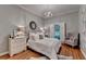 Comfortable bedroom features hardwood floors, plantation shutters, and chandelier lighting at 5475 Trowbridge Dr, Dunwoody, GA 30338