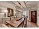 Dining room with rustic table, elegant chairs, decorative lighting, and classic decor at 5475 Trowbridge Dr, Dunwoody, GA 30338