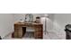 Rustic home office with a wooden desk with multiple drawers and decorative mirror at 5475 Trowbridge Dr, Dunwoody, GA 30338