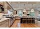 Modern kitchen with custom cabinetry, large island, stainless appliances, and hardwood floors at 5475 Trowbridge Dr, Dunwoody, GA 30338