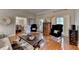 Bright living area with wood floors, black accent chairs, and view into the dining room at 5475 Trowbridge Dr, Dunwoody, GA 30338