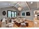 Open-concept living room with a brick fireplace, wood floors, and lots of natural light at 5475 Trowbridge Dr, Dunwoody, GA 30338