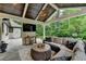 Inviting covered patio with comfortable seating, TV, and wood-burning fireplace at 5475 Trowbridge Dr, Dunwoody, GA 30338
