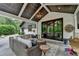 Inviting covered patio with comfortable seating and an elegant ceiling at 5475 Trowbridge Dr, Dunwoody, GA 30338