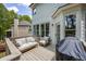 Expansive backyard deck featuring comfortable seating, a grill, and a view of the surrounding greenery at 6000 Hampton Bluff Way, Roswell, GA 30075