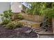 Backyard featuring a sloped landscaped yard with tiered steps leading to a fenced perimeter at 6000 Hampton Bluff Way, Roswell, GA 30075
