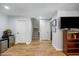Finished basement area with hardwood floors, TV area, and extra storage at 6000 Hampton Bluff Way, Roswell, GA 30075
