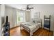 Bedroom with hardwood floors, a large window, and stylish decor, offering a comfortable and inviting space at 6000 Hampton Bluff Way, Roswell, GA 30075