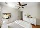 Bedroom featuring hardwood floors, ceiling fan, and ample storage and dresser space at 6000 Hampton Bluff Way, Roswell, GA 30075