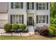 Beautiful home with white painted brick, dark shutters, manicured landscaping, and charming front entrance at 6000 Hampton Bluff Way, Roswell, GA 30075
