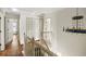 Bright hallway with wood floors, closet, modern lighting, and access to multiple rooms in the home at 6000 Hampton Bluff Way, Roswell, GA 30075