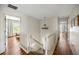 Second floor hallway with wood floors leads to bedrooms and an open view of the staircase at 6000 Hampton Bluff Way, Roswell, GA 30075