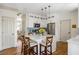 Stylish kitchen with white cabinetry, stainless steel appliances, center island, and hardwood floors offering a modern design at 6000 Hampton Bluff Way, Roswell, GA 30075