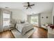 Serene bedroom features vaulted ceilings, wood floors, and natural light from surrounding windows at 6000 Hampton Bluff Way, Roswell, GA 30075