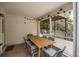 Covered porch with an outdoor dining table and comfortable seating for enjoying meals outside at 6000 Hampton Bluff Way, Roswell, GA 30075