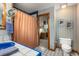 Unique bathroom with blue sink, patterned wallpaper, and a view into an adjacent room at 6525 Old Riverside Nw Dr, Sandy Springs, GA 30328