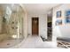 Bathroom with a glass-enclosed shower featuring multiple jets and a view of the closet with storage at 6525 Old Riverside Nw Dr, Sandy Springs, GA 30328