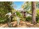 Home exterior showcasing the architecture, set amongst mature trees and lush landscaping at 6525 Old Riverside Nw Dr, Sandy Springs, GA 30328