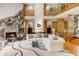 Expansive living room featuring a stone fireplace, soaring ceilings, and a spacious seating area filled with natural light at 6525 Old Riverside Nw Dr, Sandy Springs, GA 30328