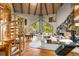 Inviting living room with a spiral staircase, floor to ceiling windows, and a stone fireplace offering ample seating at 6525 Old Riverside Nw Dr, Sandy Springs, GA 30328