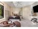 Main bedroom featuring a four-poster bed, large windows, and neutral decor at 6525 Old Riverside Nw Dr, Sandy Springs, GA 30328