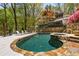 Outdoor pool and deck area with lush landscaping, seating, and resort-like amenities at 6525 Old Riverside Nw Dr, Sandy Springs, GA 30328