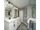 Bathroom with double vanity, white cabinets and dark fixtures at 1261 Lavista Rd # N4, Atlanta, GA 30324