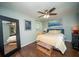 Comfortable bedroom with hardwood floors, a ceiling fan, and a large mirror at 1261 Lavista Rd # N4, Atlanta, GA 30324