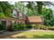 Traditional brick home featuring a well-maintained lawn, mature trees, and classic architectural details at 1261 Lavista Rd # N4, Atlanta, GA 30324