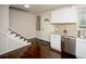 Charming kitchen area showcasing stainless steel appliances, light countertops, and an adjacent stairway and entry at 1261 Lavista Rd # N4, Atlanta, GA 30324