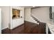 Brightly lit kitchen area leading to a stairway and showcasing granite countertops, white cabinets and hardwood floors at 1261 Lavista Rd # N4, Atlanta, GA 30324