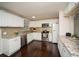 Bright kitchen featuring white cabinets, stainless steel appliances, granite countertops, and a stylish backsplash at 1261 Lavista Rd # N4, Atlanta, GA 30324