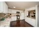 Well-lit kitchen featuring white cabinets, stainless steel appliances, granite countertops, and dark hardwood floors at 1261 Lavista Rd # N4, Atlanta, GA 30324