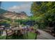Outdoor patio with dining table, umbrella, potted plants, and seating area surrounded by lush greenery at 1261 Lavista Rd # N4, Atlanta, GA 30324